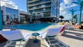 The outdoor amenities with a swimming pool, cabanas and lounge chairs at the Wave Hotel at Lake Nona in Orlando, Florida