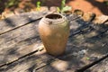 Outdoor ancient pottery jug on weathered wood background