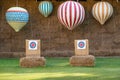 Outdoor archery targets on grass field surrounded by forest in t