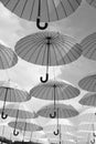 Outdoor art design and decor. Umbrellas float in sky on sunny day. Umbrella sky project installation. Holiday and