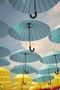 Outdoor art design and decor. Umbrellas float in sky on sunny day. Umbrella sky project installation. Holiday and