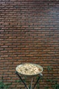 Outdoor metal ashtray with red brick wall background