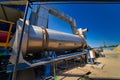 Outdoor asphalt mixes station. Loading equipment. Asphalt mixture. Selective focus. Royalty Free Stock Photo