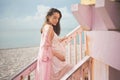 Beautiful pregnant woman on the lifeguard tower