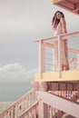 Beautiful pregnant woman on the lifeguard tower