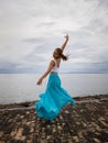 Outdoor ballet practice. Beautiful Caucasian woman practicing ballet pose. Young ballerina wearing long blue skirt, dancing and Royalty Free Stock Photo