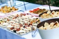 Outdoor banquet table with many snacks and delicacies Royalty Free Stock Photo