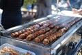 Outdoor barbecue with assorted grilled sausages on a grill