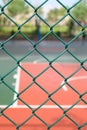 outdoor basketball court behind metal fence vertical composition