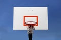 Outdoor Basketball Hoop and Backboard Isolated Against Blue Sky