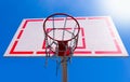 Outdoor basketball hoop with blue sky