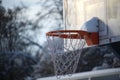 Outdoor basketball hoop covered with a layer of snow