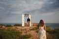 Outdoor beach wedding ceremony, stylish happy groom is standing near wedding arch on the sea shore waiting for the bride Royalty Free Stock Photo