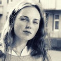 Outdoor beauty. Portrait of smiling young and happy woman with freckles. Black and white. Royalty Free Stock Photo