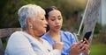 Outdoor, bench and nurse with old woman, smartphone and connection with social media, conversation and internet Royalty Free Stock Photo