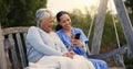 Outdoor, bench and nurse with senior woman, cellphone and connection with social media, conversation and internet Royalty Free Stock Photo