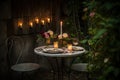 outdoor bistro set with candlelight and fresh flowers for a romantic setting Royalty Free Stock Photo