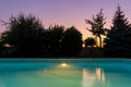 Outdoor blue liner swimming pool at dusk