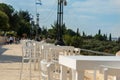 Jerusalem Armon Hanatziv Promenade in the sunny day.Tables and chairs of restaurant stand on the street waiting for Royalty Free Stock Photo