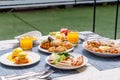 Outdoor breakfast setting with eggs Benedict Royalty Free Stock Photo