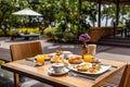 Outdoor breakfast setting with fresh juice Royalty Free Stock Photo