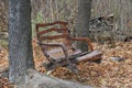 Outdoor brown wooden swing hanging from trees