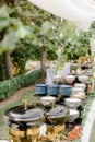 Outdoor buffet featuring a variety of vibrant colored dishes set up at an outdoor event venue Royalty Free Stock Photo