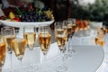 Outdoor buffet with glasses of champagne and wine.