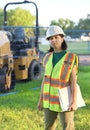 Outdoor builder portrait, construction woman worker standing near workplace