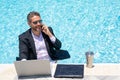 Outdoor business. Businessman tourist in suit rest on beach with laptop outdoor. Business man outdoor on summer vacation