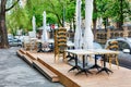 The outdoor cafe outdoor area is closed, outdoor furniture, tables, chairs and umbrellas are chained together Royalty Free Stock Photo