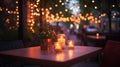 Romantic Outdoor Table with Candles and Fairy Lights, Cozy Evening Scene Royalty Free Stock Photo