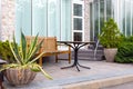 An outdoor cafe with stone flowerpots and plants.