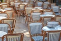 Outdoor cafe tables and chairs in a sunny day Royalty Free Stock Photo