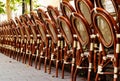 Outdoor cafe terrace with rattan patio chairs stacked and lined up in a row Royalty Free Stock Photo