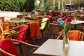 Outdoor cafe with wicker chairs and wooden tables Royalty Free Stock Photo