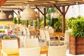 Outdoor cafe with wicker furniture and lamps. Blurred image Royalty Free Stock Photo