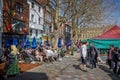 Outdoor cafes full of people at the Salisbury Saturday Market in Salisbury, Wiltshire, UK