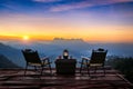 Outdoor camping table set at sunrise. Doi Luang Chiang Dao mountains in Chiang Mai