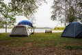 Outdoor camping tent near lake, The cart is between the tents, holiday activities Royalty Free Stock Photo