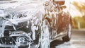 Outdoor car wash with active foam soap. commercial cleaning washing service concept. Leave space to write messages. Royalty Free Stock Photo
