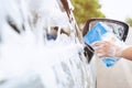 Outdoor Car wash worker Cleaning stains with foam Royalty Free Stock Photo