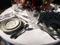 Outdoor catering dinner. Floral design. Vintage glasses and tableware. Romantic table setting with white tablecloth. bouquet Royalty Free Stock Photo
