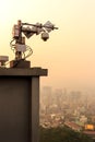 Outdoor CCTV security camera on high rise building rooftop in poor weather morning Royalty Free Stock Photo