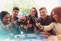 Outdoor, celebration and friends with beer, toast and cheers with party and restaurant with social gathering. People Royalty Free Stock Photo