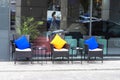 outdoor chairs with cushions and tables for a smoke break and snack on the street near the office center. Royalty Free Stock Photo