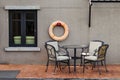 Chairs and table place nearly swimming pool.