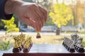 Outdoor chess game. Chessboard with figures on an autumn park background, close-up. Royalty Free Stock Photo