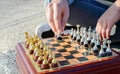 Outdoor chess game. Wooden chessboard with silver and gold pieces Royalty Free Stock Photo