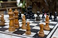 Outdoor chessboard with black and yellow figures with unfocused background. Competition and strategy concept. Intelligent sport. Royalty Free Stock Photo